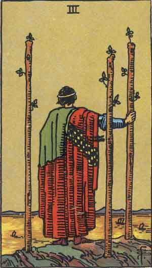 The Three of Wands tarot card meanings depicts a man and three wands as he looks off the cliff edge to see what lies ahead.